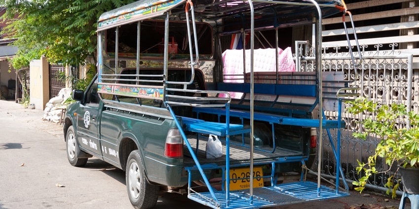 Explore the town of Phuket on a Songthaew, which is a mode of transportation in Thailand.