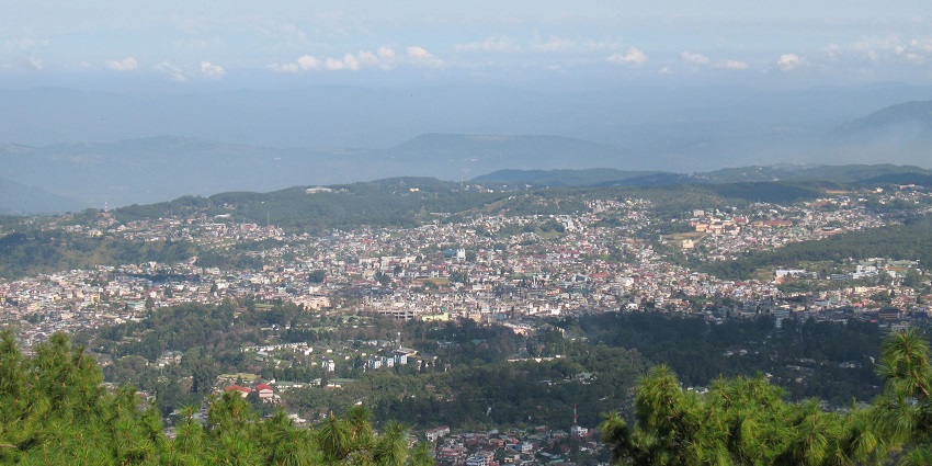 A picture of a hill town taken from another mountain in Shillong