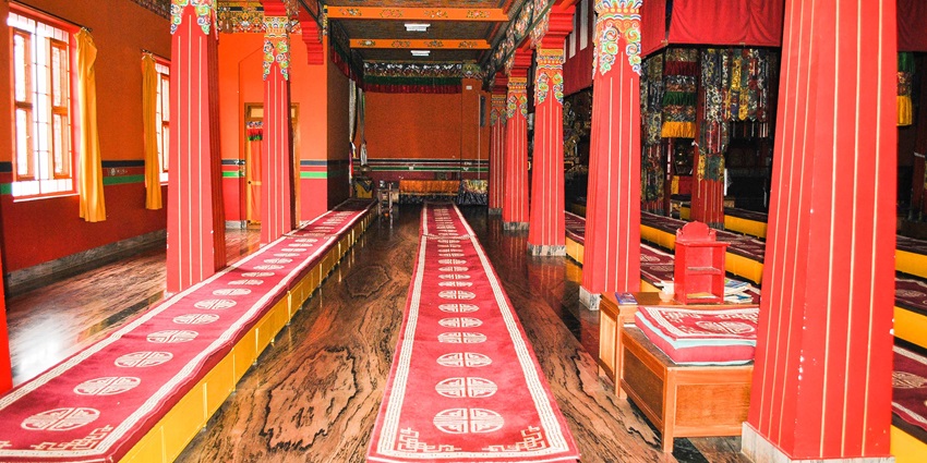 The interior view of Mirik Monastery that has intricate carvings and handmade paintings.