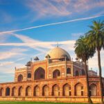 A picture of a famous tomb in Delhi with a big garden area in the front separated by a walkway