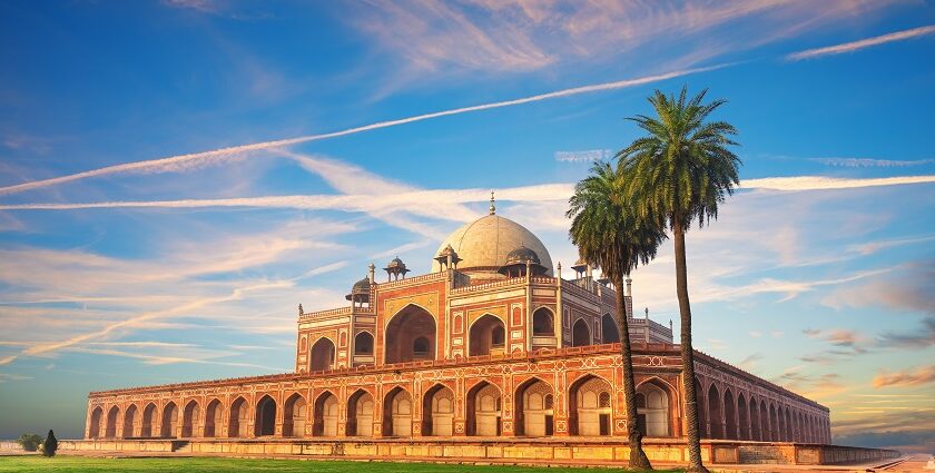 A picture of a famous tomb in Delhi with a big garden area in the front separated by a walkway