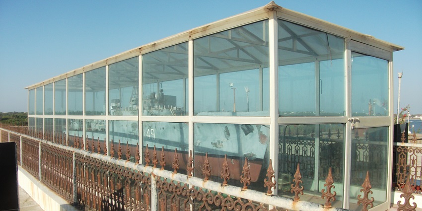 A picture of the model of a navy battleship at a memorial in Diu