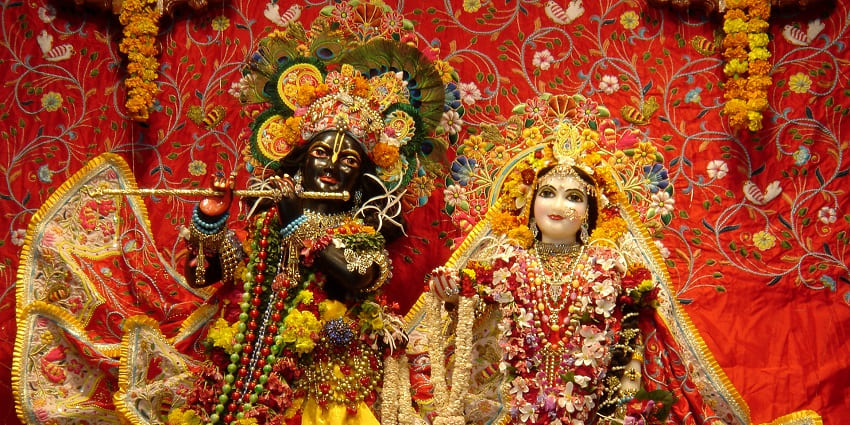 Radha Syamasundar deities in Vrindavan adorned with flowers and festive decorations.