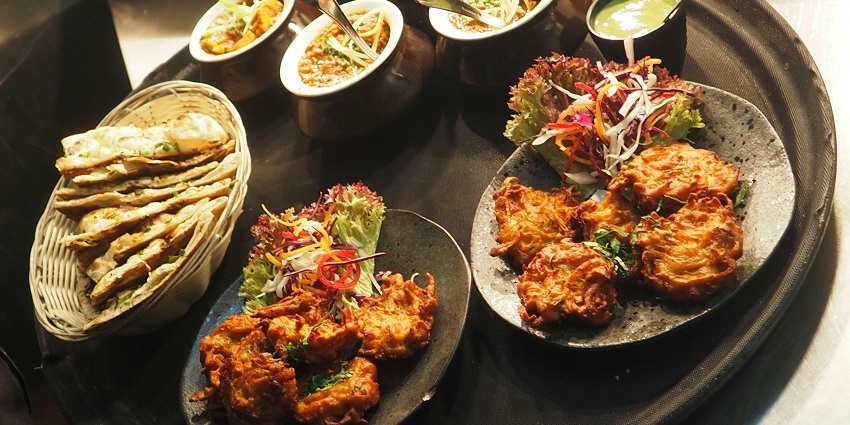 A deliciously arranged meal on a sleek black tray, highlighting the dish's colourful ingredients.