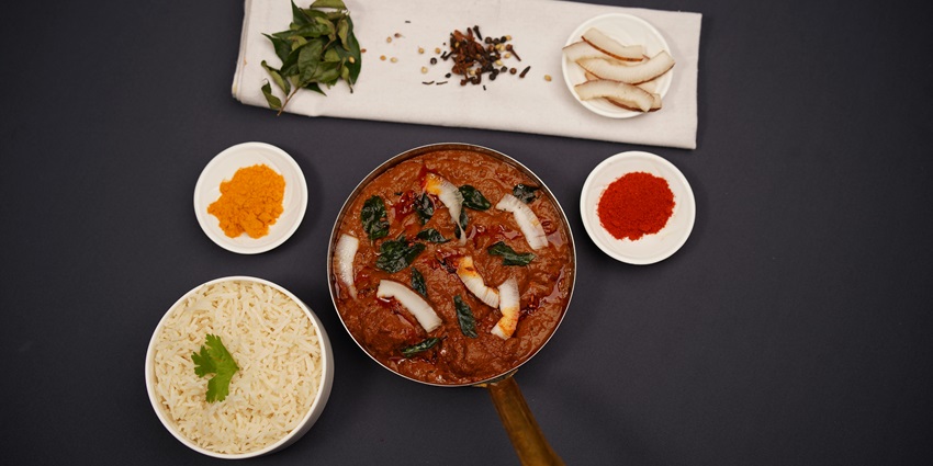 Indian food on the table - curry and rice and on side coconut - traditional Kerala cuisine