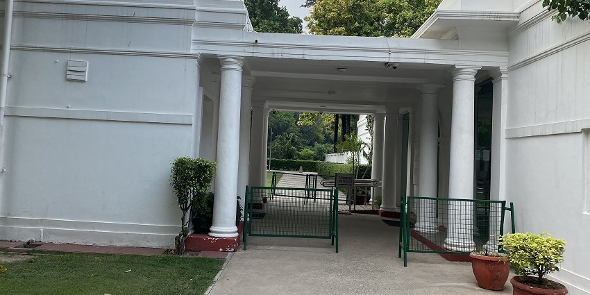Front view of Indira Gandhi Memorial Museum with white facade and garden walkway.