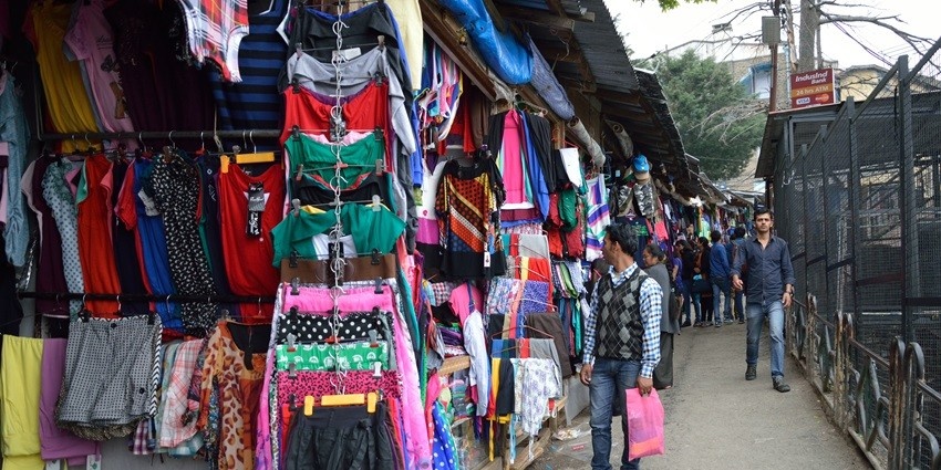 People buying clothes at a market in Dalhousie