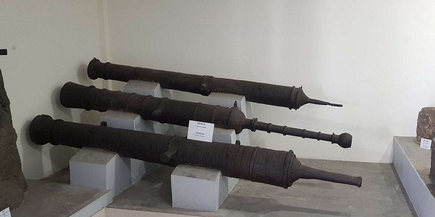 Three cannons on display at the Medieval Assam State Museum, showcasing historical weapons.