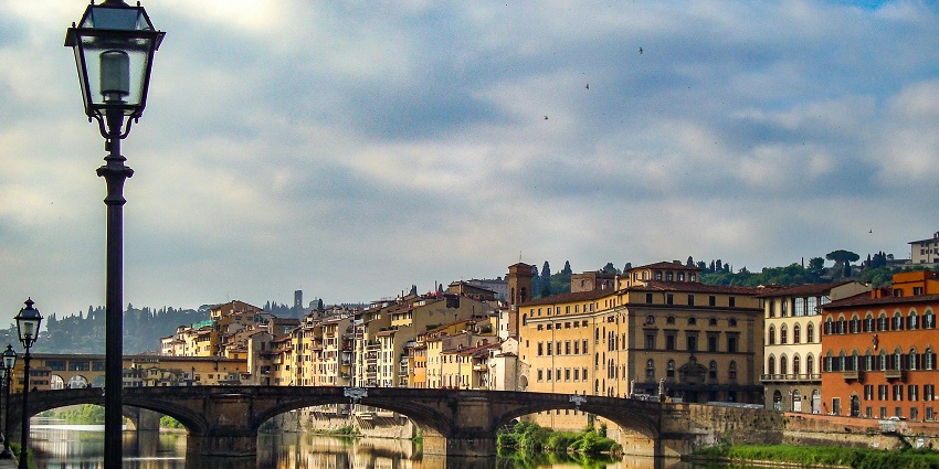 A mesmerising view of concrete buildings near a sparkling body of water during the day.