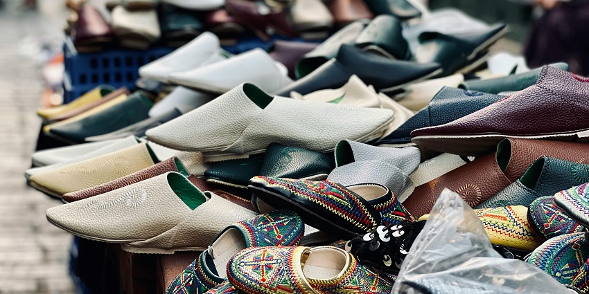 A picture of shoes for kids and adults kept at a stall at a street market in Morocco