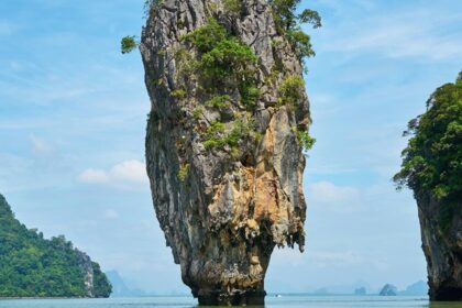 A scenic view of majestic peaks nestled amidst the azure waters of an island in Thailand.