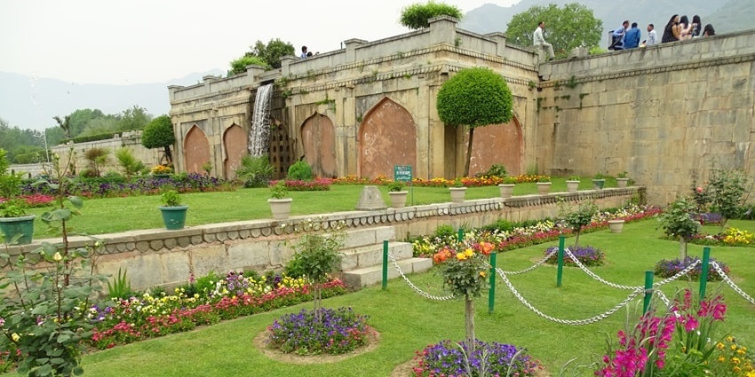 Picturesque view of the vibrant flowerbeds amidst verdant meadows inside a garden