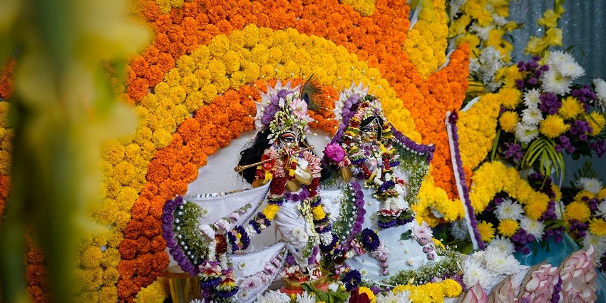 Image of lord Krishna during Janmashtami celebration with colourful decorations.