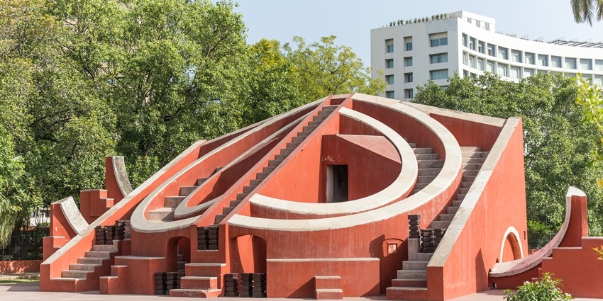 View of the Jantar Mantar surrounded by greenery in broad daylight