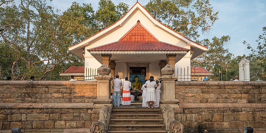 Serene view of the Jaya Sri Maha Bodhi tree, surrounded by devotees in Anuradhapura.