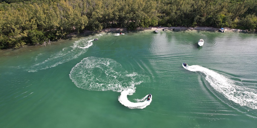 A group of people enjoying jet skiing in Dubai waters