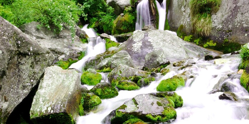 A glimpse of shimmering waters of Jogini Waterfalls cascading down to the stream.
