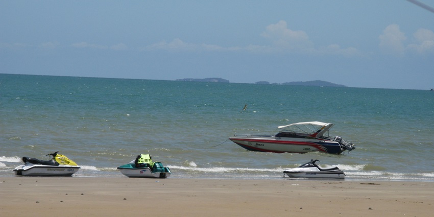 Serene Jomtien Beach view with soft sand, calm waters, and a peaceful shoreline.