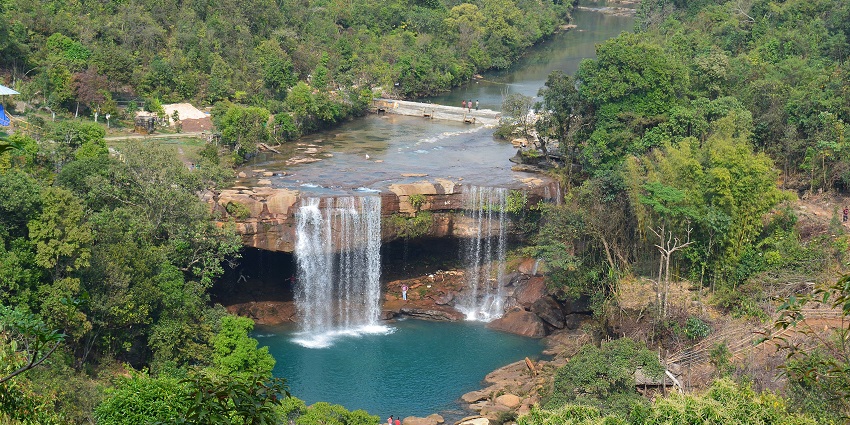A waterfall cascading serenely from a rock to form a pond in the bottom