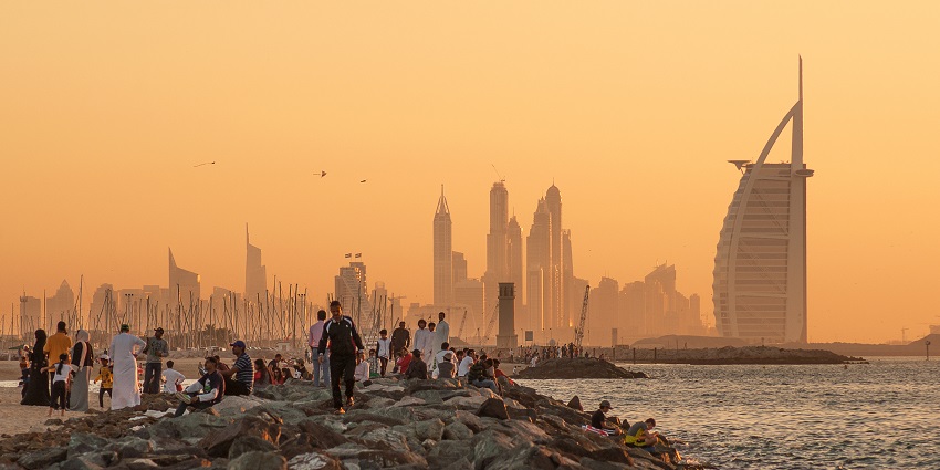 A mesmerising view of sunset with people enjoying near the popular Jumeirah Beach