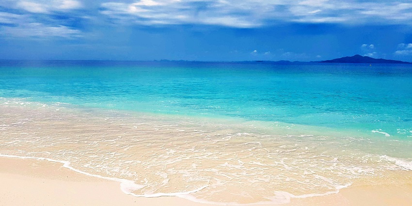 A view of waves hitting the shoreline of Kamala Beach, one of the top beaches in Phuket.