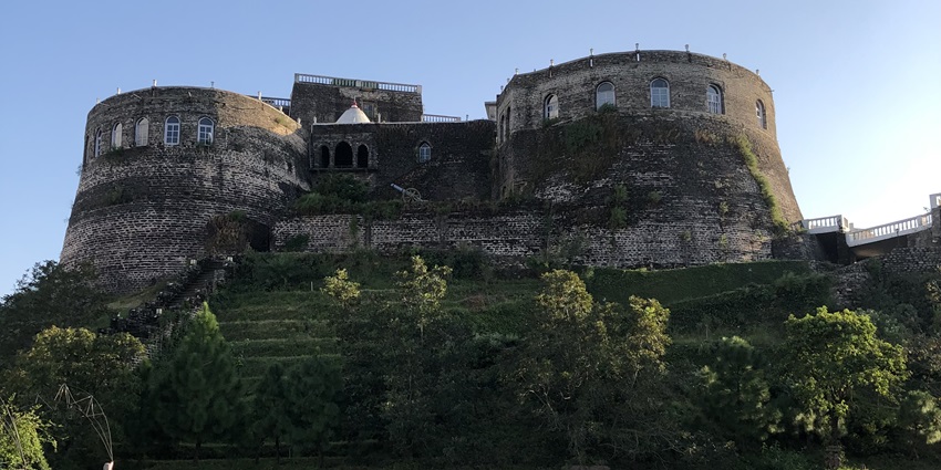 Image of the Kamru fort surrounded by trees, one of the places to visit in Kinnaur for history lovers
