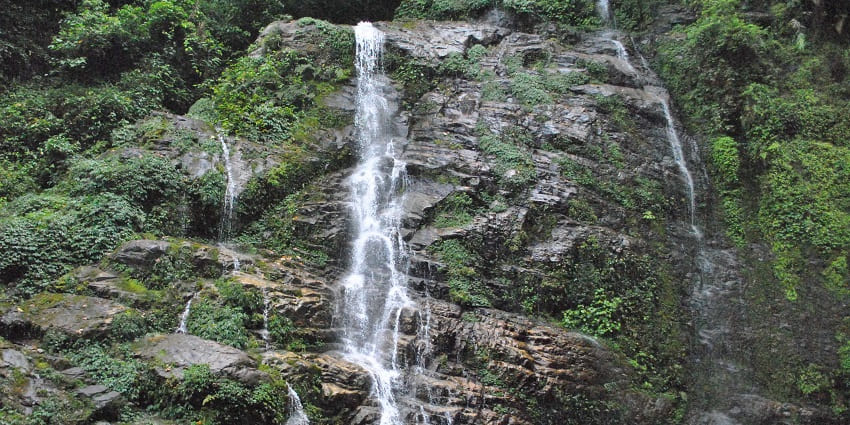 A mesmerising view of the cascading Kanchenjunga Falls from the rocky mountain cliffs
