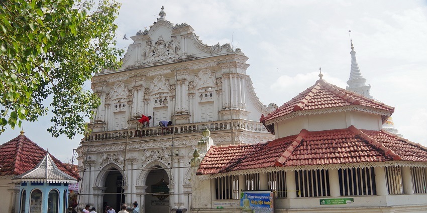 Ancient temple with ornate architecture and lush greenery surrounding it -Places to visit in Bentota.
