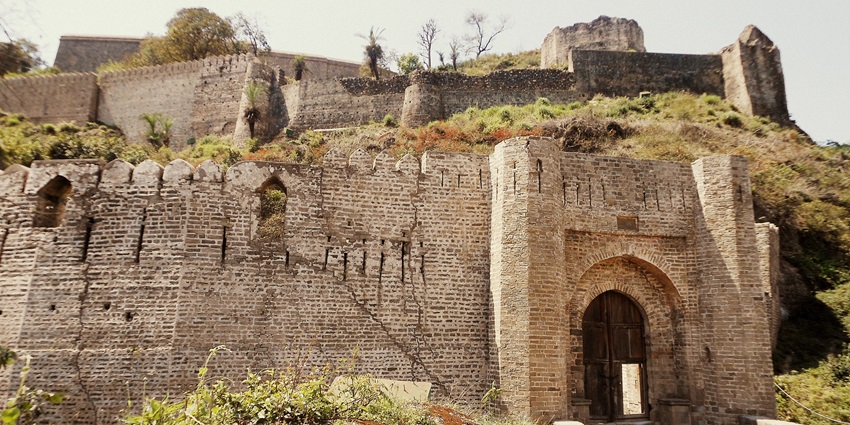 A frontal view of a ruined fort in Himachal Pradesh with destroyed gardens all around