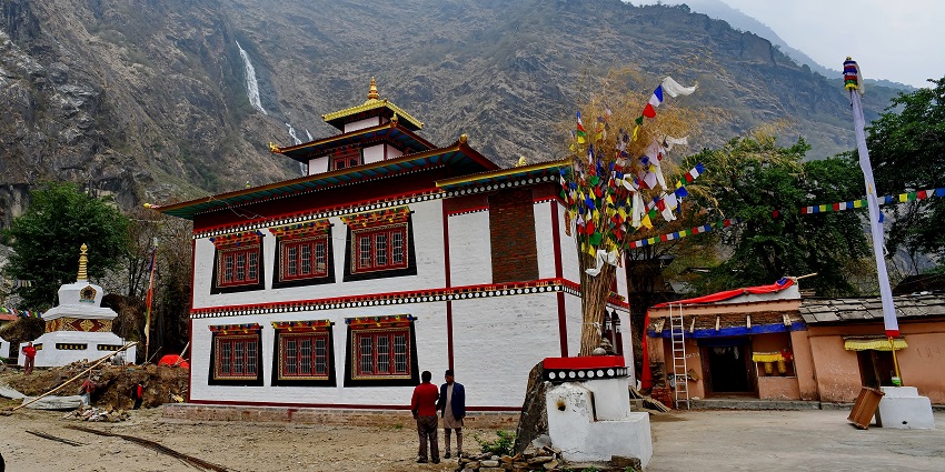 A breathtaking view of Kardang Monastery with red and white architecture during the day.