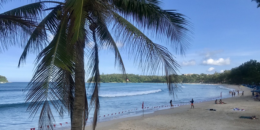 Waves hitting the sandy shores of Kata Beach, one of the top beaches in Thailand.