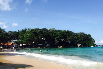 A mesmerising view of turquoise waters and lush green landscapes in Phuket, Thailand.