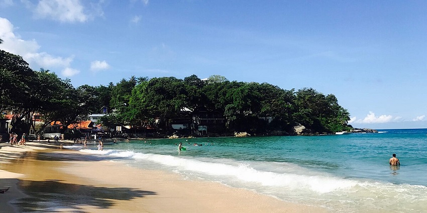 Snapshot of Kata beach surrounded by a beautiful lush dense forest and ocean
