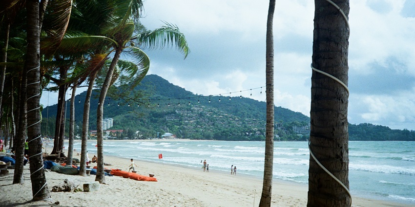 Relax at the beaches in Phuket, Thailand by looking at the calm waters of the sea.