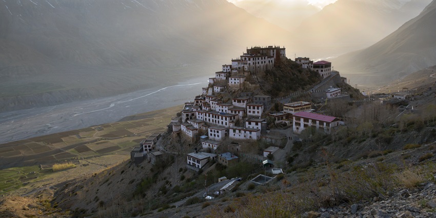 beautiful image of the stepped key monastery located on the hills near kibber sanctuary