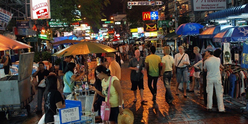 Khao San Road transforms into a street alive with music, dancing, and impromptu parties.