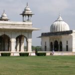 A picture of a white monument in Delhi with a large garden in its front