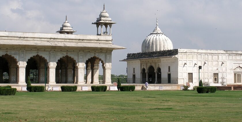 A picture of a white monument in Delhi with a large garden in its front