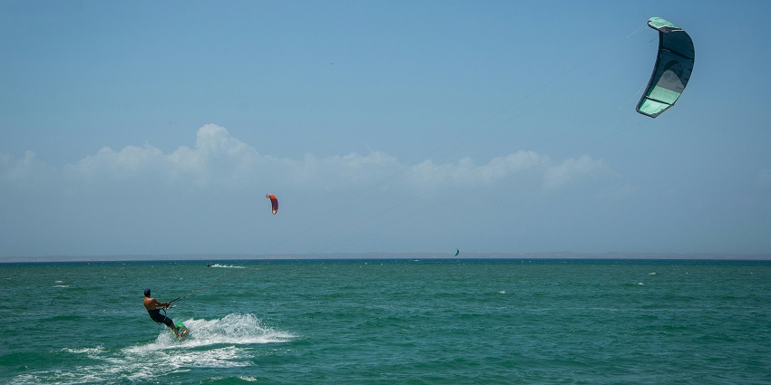 Man kitesurfing across the water, showcasing an exciting water sport in Vietnam.