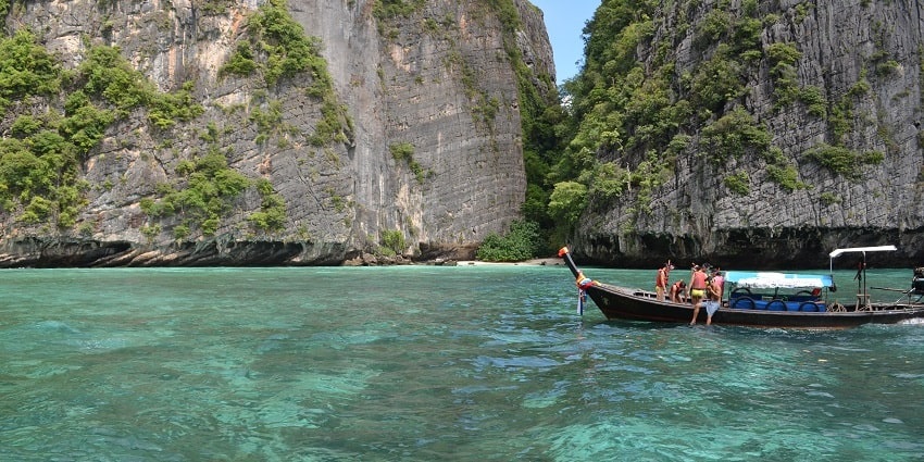 Panoramic views of a boat on the blue lagoon of the Phi Phi island and its surroundings