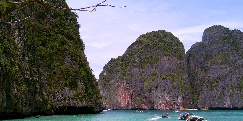 People spending their leisure time on the pristine beaches of Koh Phi Phi Island.