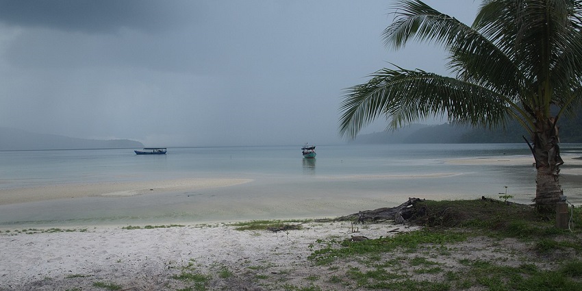 A breathtaking vista of Koh Rong Samloem featuring azure waters, sands, and palm trees.