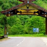 An entrance with a Welcome sign on a wooden board, on the way to Kohima, a town in Nagaland.