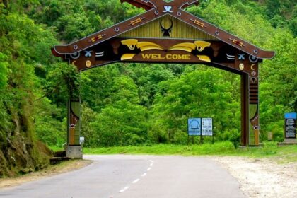 An entrance with a Welcome sign on a wooden board, on the way to Kohima, a town in Nagaland.