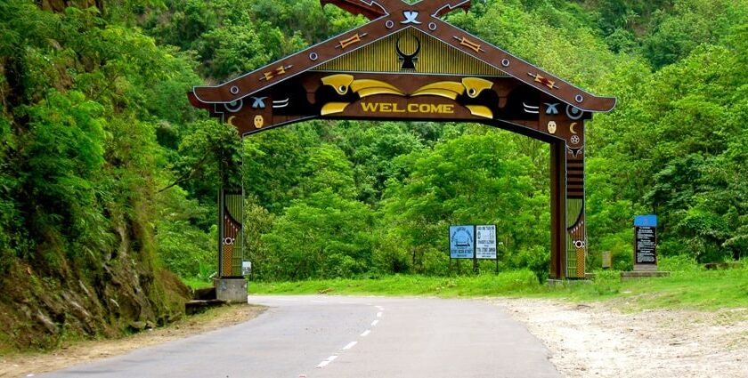 An entrance with a Welcome sign on a wooden board, on the way to Kohima, a town in Nagaland.