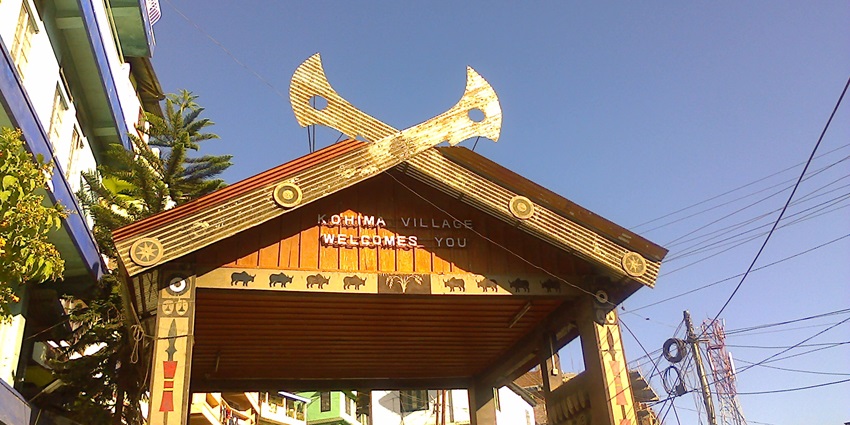 Traditional Naga architecture, vibrant cultural elements, and scenic hillside views.