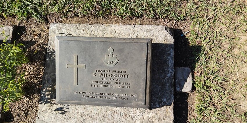 A solemn memorial with neatly arranged graves, lush gardens, and peaceful surroundings