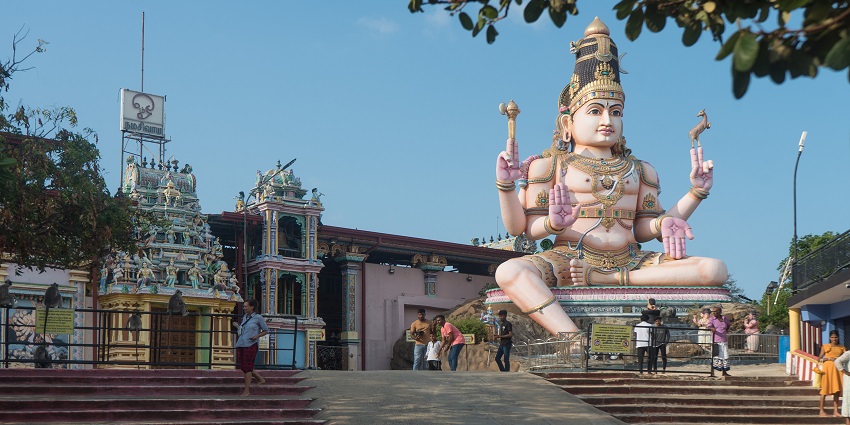 Stunning view of Koneswaram Temple, featuring detailed carvings and lush greenery.