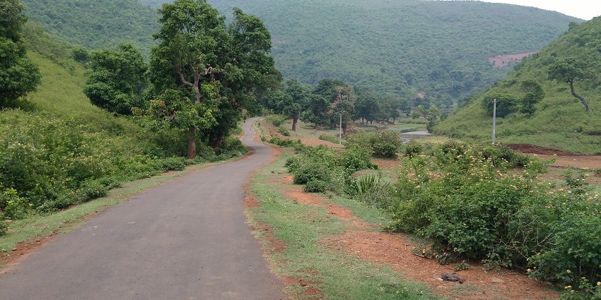 Road to Raniduduma Waterfall in Koraput, Odisha, rocky terrain surrounded by dense forest.