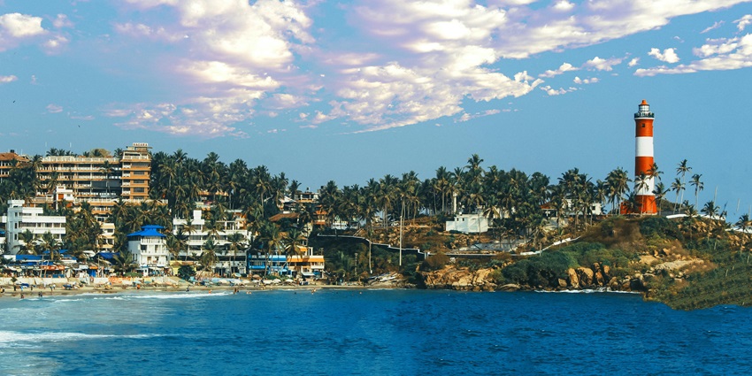 Image of Kovalam Beach view surrounded by a Kovalam city and a lighthouse around the corner